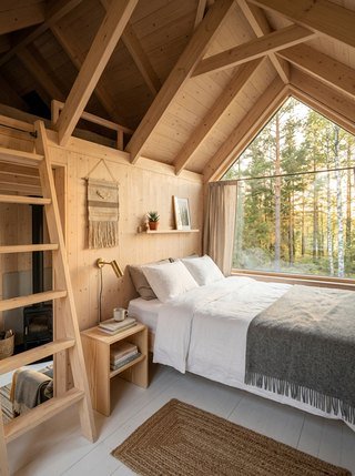 Loft sleeping area in a Scandinavian tiny house, catching golden hour light from a gable window